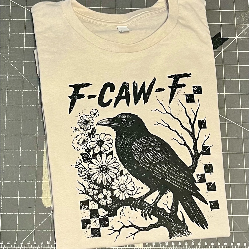 Bella Canvas Cream Graphic Tee with Black Design